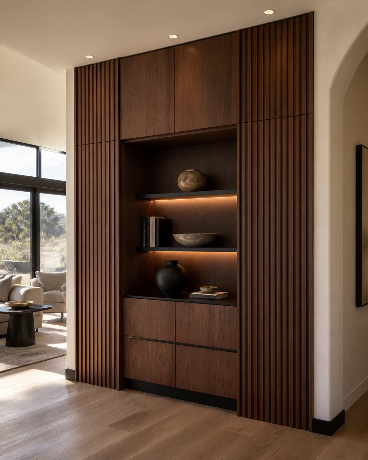 Detailed dark walnut cabinet wall with softly illuminated shelves and concealed storage